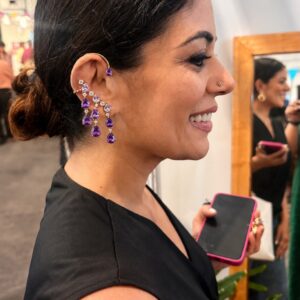 Model wearing Cosmic gold-plated earcuffs with cascading colourful AD stone drops in lifestyle setting