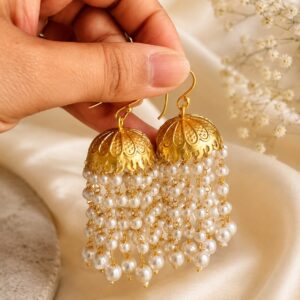 Pearl Muthukuda traditional jhumka earrings in gold-plated brass with cascading synthetic pearl bead strings
