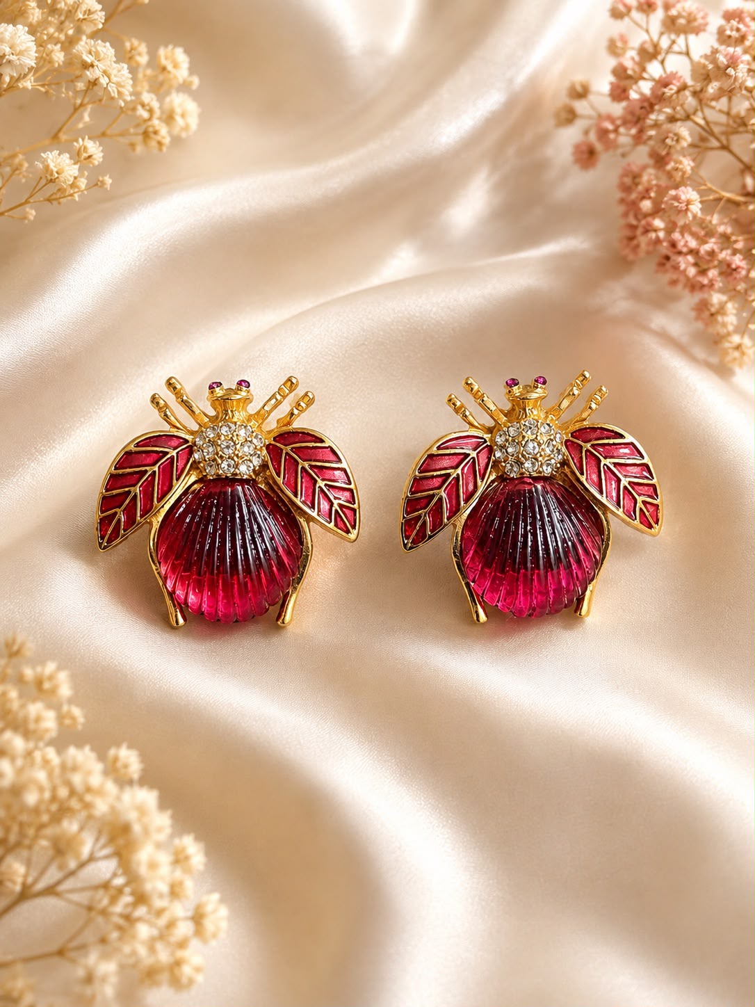 The Ruby Bug bee-inspired stud earrings in 18K gold plating with ruby-toned resin centre