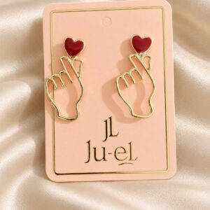Ju-el Love Earrings featuring heart and finger-heart gold-plated alloy stud design on display card