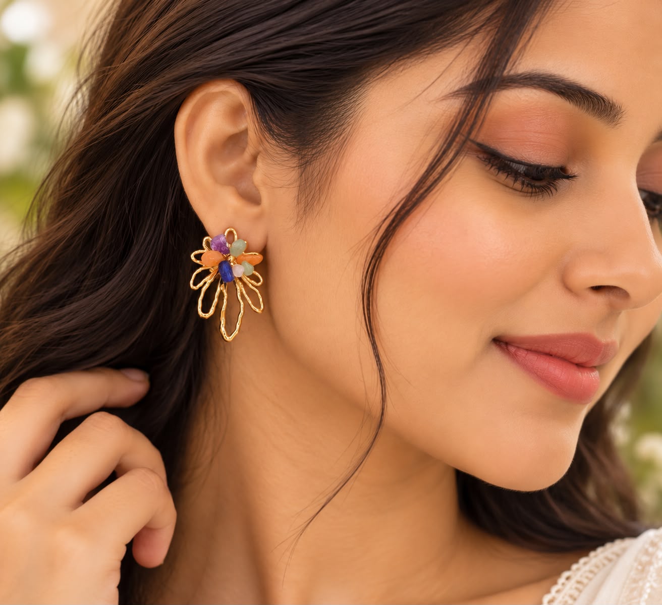 Model wearing Ju-el Petal Bloom Earrings with 18K gold plated open-work petals and natural stone cluster